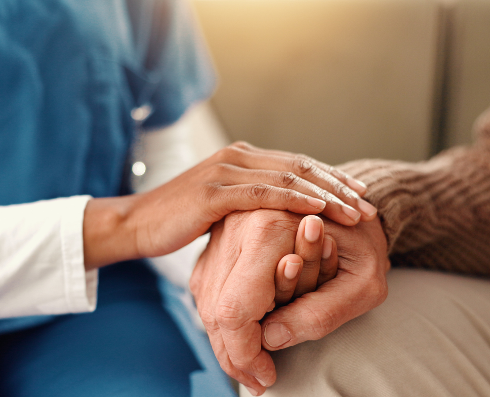 Woman holding an elderly man's hand